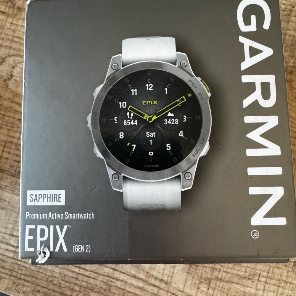 Garmin Silver Smartwatch with Circular Face and White Band